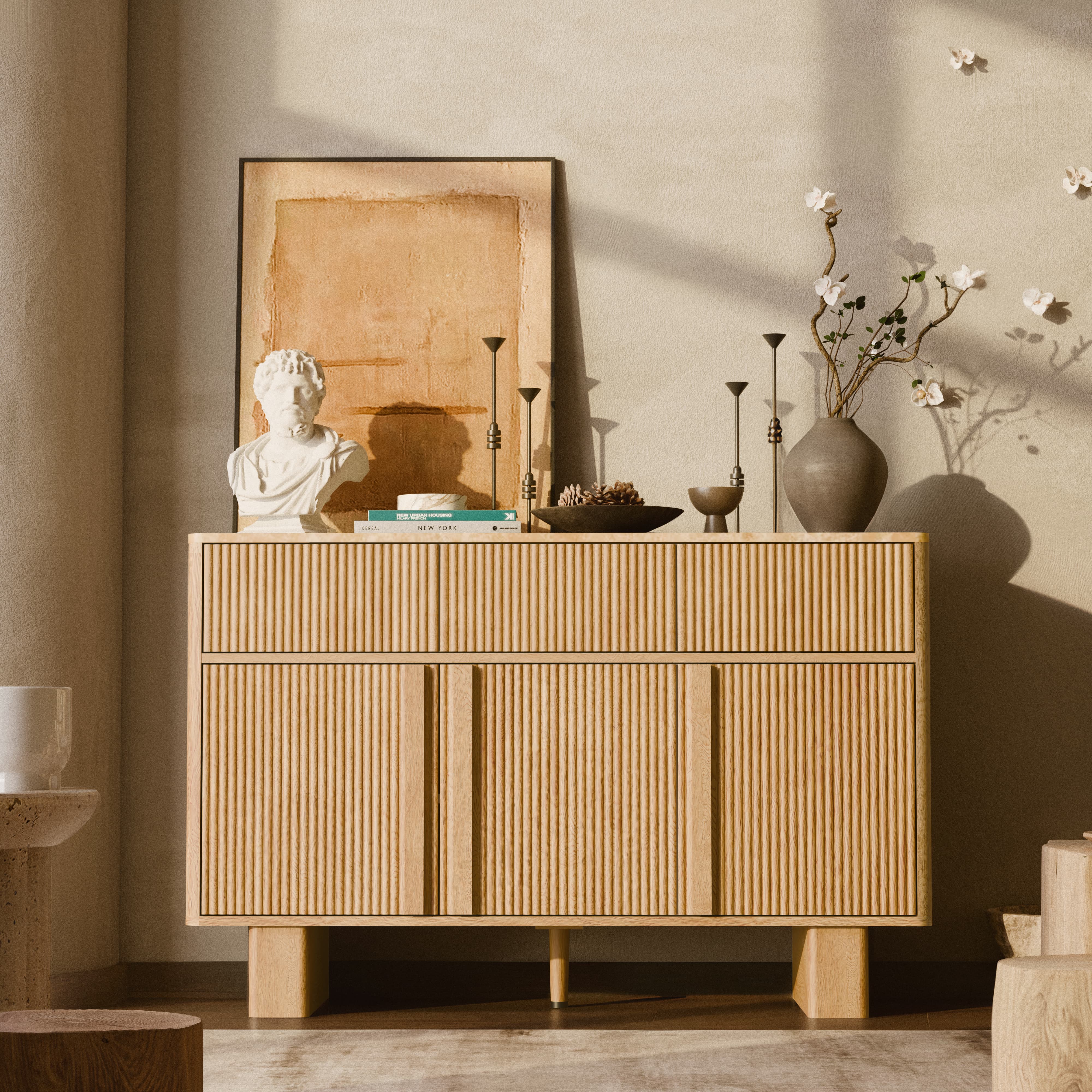 Wooden sideboard with decorative items in a room with soft lighting